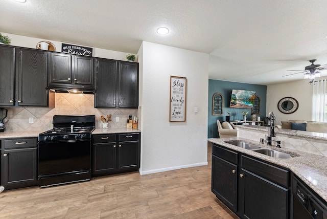 14706 Meadow Acre Trl, Houston, TX 77049 - kitchen with black appliances, open floor plan, a sink, under cabinet range hood, and a ceiling fan