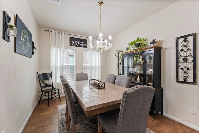 14706 Meadow Acre Trl, Houston, TX 77049 - dining room featuring a chandelier, dark wood-style floors, and baseboards