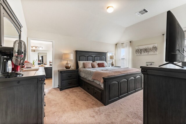 14706 Meadow Acre Trl, Houston, TX 77049 - bedroom featuring light carpet, vaulted ceiling, and connected bathroom