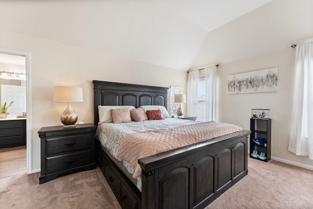 14706 Meadow Acre Trl, Houston, TX 77049 - bedroom with light colored carpet, vaulted ceiling, baseboards, and ensuite bath