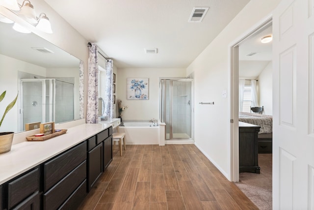 14706 Meadow Acre Trl, Houston, TX 77049 - ensuite bathroom with a stall shower, vanity, a bath, wood finished floors, and baseboards