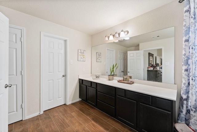 14706 Meadow Acre Trl, Houston, TX 77049 - full bathroom with baseboards, wood finished floors, and double vanity