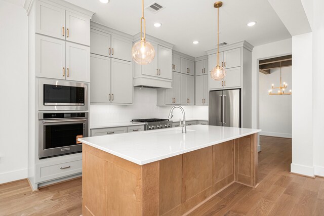7913 Turquoise Ln, Houston, TX 77055 - kitchen featuring appliances with stainless steel finishes, baseboards, light wood-style floors, light countertops, and recessed lighting