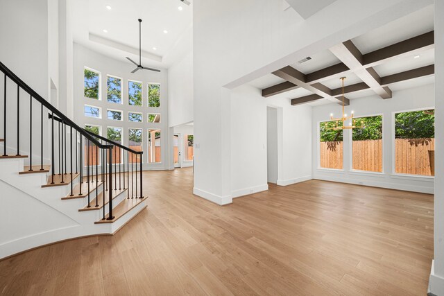 7913 Turquoise Ln, Houston, TX 77055 - unfurnished living room with beam ceiling, a ceiling fan, light wood-style flooring, a chandelier, and recessed lighting
