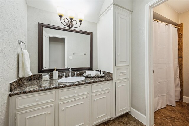 706 St Ives Ct, Houston, TX 77079 - full bath with vanity, tile patterned floors, a chandelier, a shower with shower curtain, and baseboards