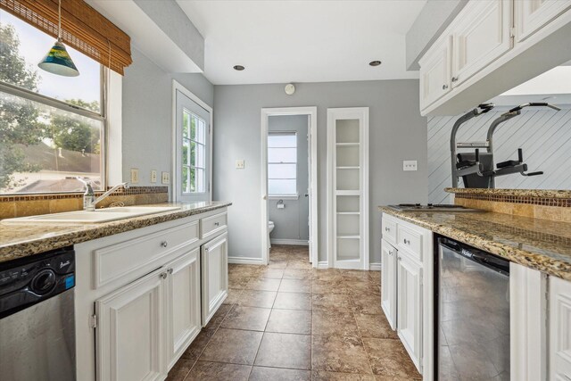 706 St Ives Ct, Houston, TX 77079 - kitchen featuring stainless steel dishwasher, a sink, tasteful backsplash, white cabinetry, and hanging light fixtures