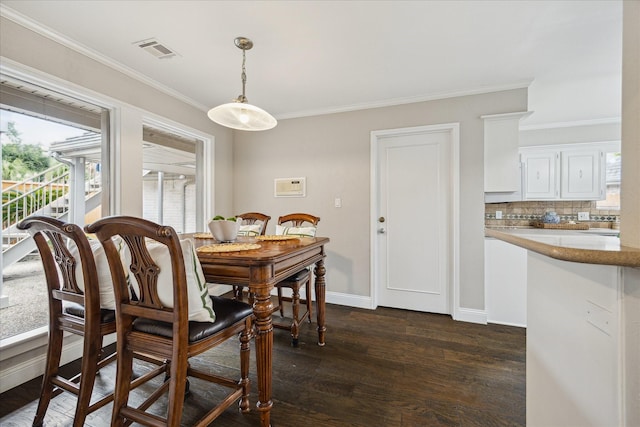 706 St Ives Ct, Houston, TX 77079 - dining area with ornamental molding, dark wood-style flooring, and baseboards