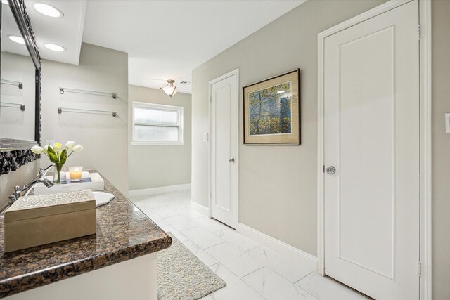 706 St Ives Ct, Houston, TX 77079 - full bath with marble finish floors, double vanity, baseboards, and recessed lighting