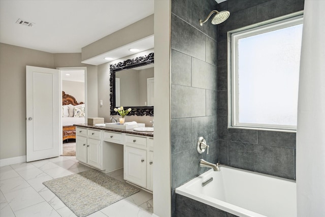 706 St Ives Ct, Houston, TX 77079 - ensuite bathroom with marble look tiles, double vanity, baseboards, and recessed lighting