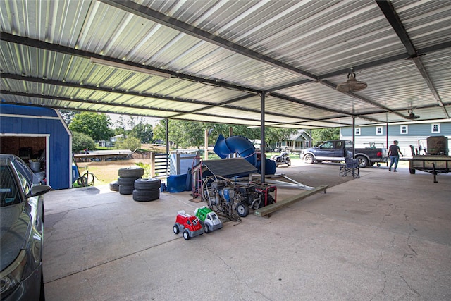 374 Harbor View Dr, Livingston, TX 77351 - garage featuring a shed and a garage door opener
