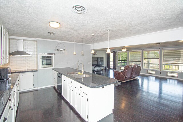 374 Harbor View Dr, Livingston, TX 77351 - kitchen featuring wall chimney exhaust hood, stainless steel appliances, a sink, a peninsula, and open floor plan