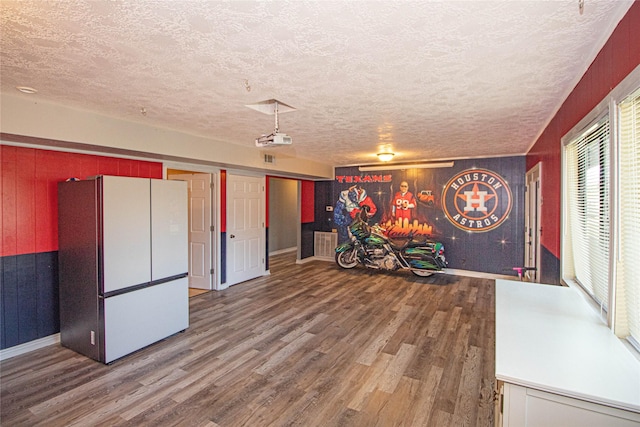 374 Harbor View Dr, Livingston, TX 77351 - rec room featuring wood walls, wood finished floors, a textured ceiling, and baseboards