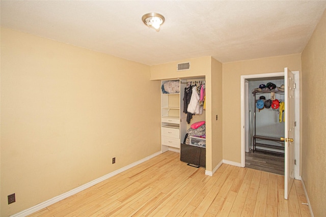 374 Harbor View Dr, Livingston, TX 77351 - bedroom with light wood-style flooring, a closet, and baseboards