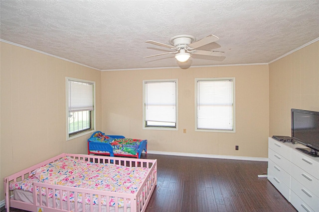 374 Harbor View Dr, Livingston, TX 77351 - bedroom featuring dark wood-style flooring, a textured ceiling, crown molding, baseboards, and a ceiling fan