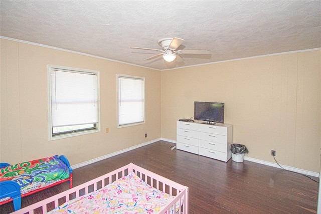 374 Harbor View Dr, Livingston, TX 77351 - bedroom featuring wood finished floors, ornamental molding, a textured ceiling, baseboards, and a ceiling fan