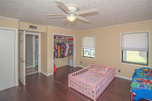 374 Harbor View Dr, Livingston, TX 77351 - bedroom featuring wood finished floors, a textured ceiling, multiple windows, a closet, and baseboards