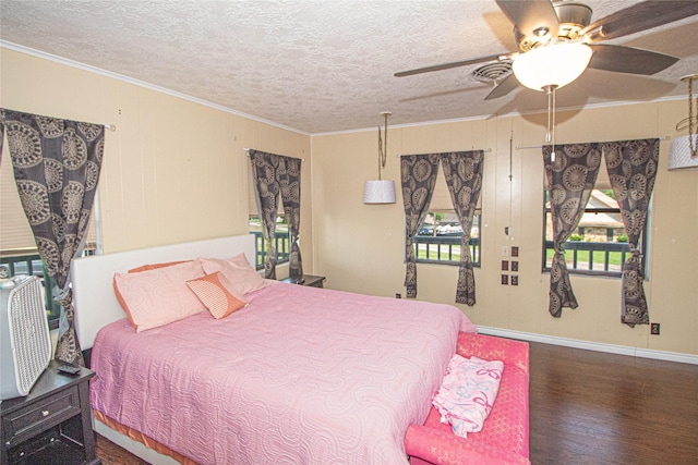 374 Harbor View Dr, Livingston, TX 77351 - bedroom featuring wood finished floors, baseboards, crown molding, a textured ceiling, and a ceiling fan