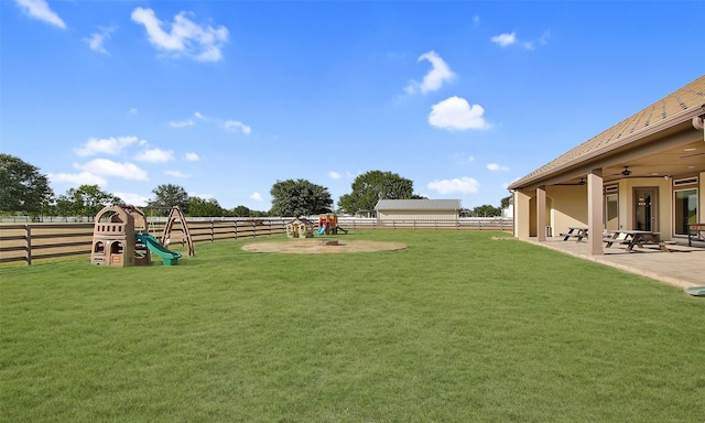 624 High Meadow Ranch Dr, Magnolia, TX 77355 - view of yard featuring a ceiling fan, a patio area, and a playground