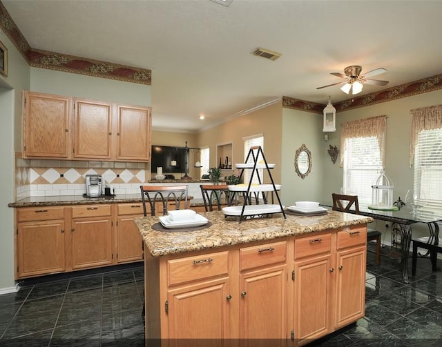 4915 Dove Springs Dr, Houston, TX 77066 - kitchen with a ceiling fan, tasteful backsplash, a center island, light stone counters, and ornamental molding