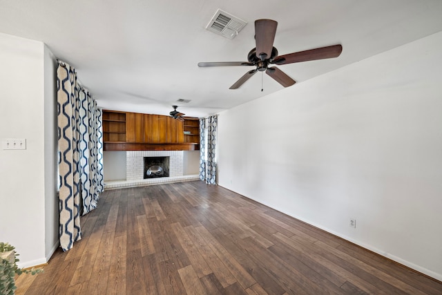 4922 Nina Lee Ln, Houston, TX 77092 - unfurnished living room featuring a ceiling fan, dark wood-style floors, a brick fireplace, and baseboards