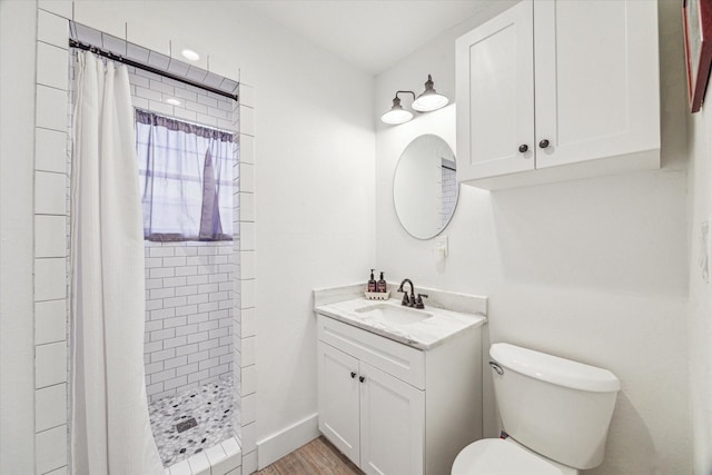 529 Fugate St, Houston, TX 77009 - bathroom featuring toilet, vanity, a tile shower, and wood finished floors