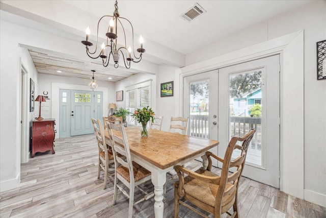 529 Fugate St, Houston, TX 77009 - dining space with light wood finished floors, a chandelier, french doors, and baseboards