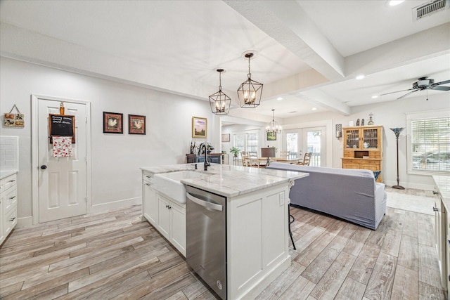 529 Fugate St, Houston, TX 77009 - kitchen with dishwasher, a sink, light wood-style flooring, white cabinets, and beam ceiling