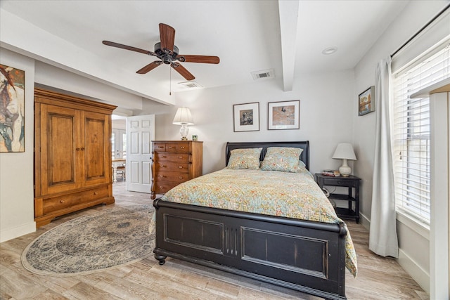 529 Fugate St, Houston, TX 77009 - bedroom featuring multiple windows, baseboards, beam ceiling, and light wood-style flooring