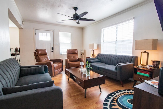 326 W 28th St, Houston, TX 77008 - living room featuring ceiling fan, light wood finished floors, and ornamental molding
