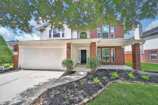 32126 Willow Creek Park, Conroe, TX 77385 - traditional home with brick siding, concrete driveway, and a garage