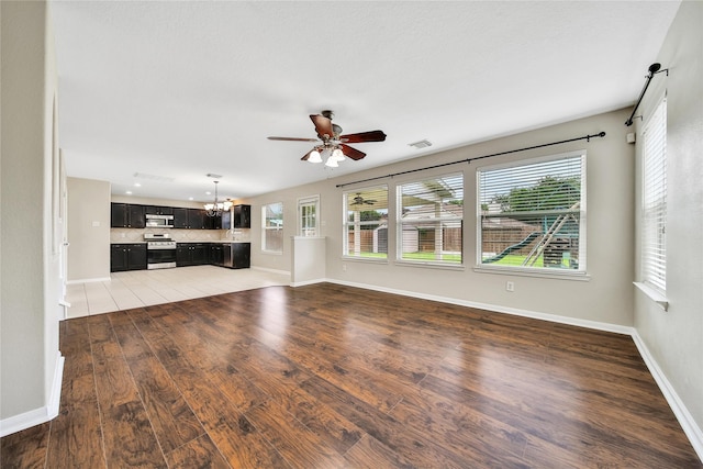 32126 Willow Creek Park, Conroe, TX 77385 - unfurnished living room with a ceiling fan, a chandelier, and light wood-type flooring