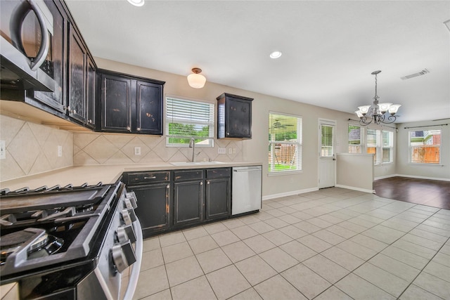 32126 Willow Creek Park, Conroe, TX 77385 - kitchen with stainless steel appliances, a chandelier, healthy amount of natural light, light countertops, and recessed lighting