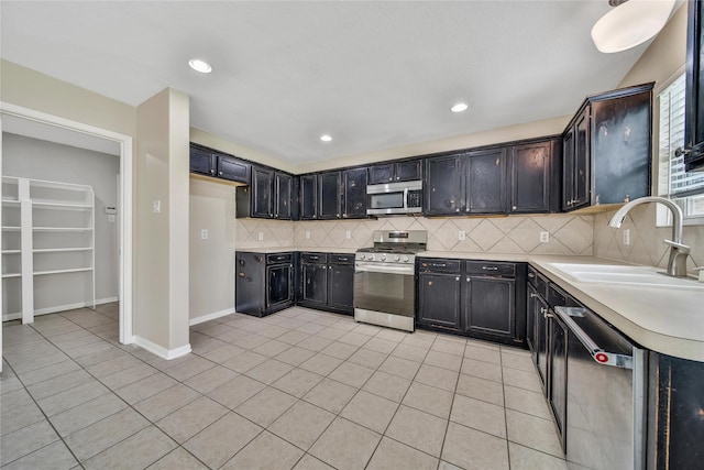 32126 Willow Creek Park, Conroe, TX 77385 - kitchen featuring appliances with stainless steel finishes, light tile patterned flooring, light countertops, backsplash, and recessed lighting