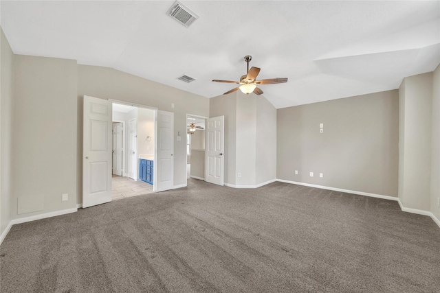 32126 Willow Creek Park, Conroe, TX 77385 - unfurnished bedroom featuring carpet flooring, lofted ceiling, connected bathroom, and ceiling fan