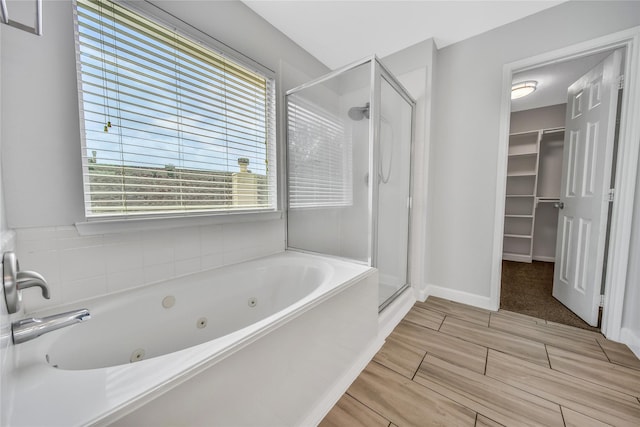 32126 Willow Creek Park, Conroe, TX 77385 - bathroom featuring a shower stall, a whirlpool tub, a spacious closet, and wood finish floors