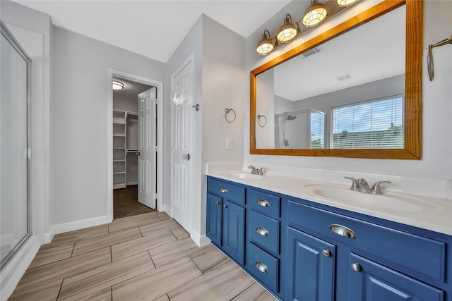 32126 Willow Creek Park, Conroe, TX 77385 - bathroom featuring an enclosed shower, double vanity, wood finish floors, and a walk in closet