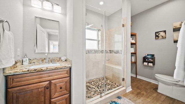 21530 San Luis Pass Rd, Galveston, TX 77554 - full bath featuring toilet, wood finished floors, a stall shower, vanity, and baseboards