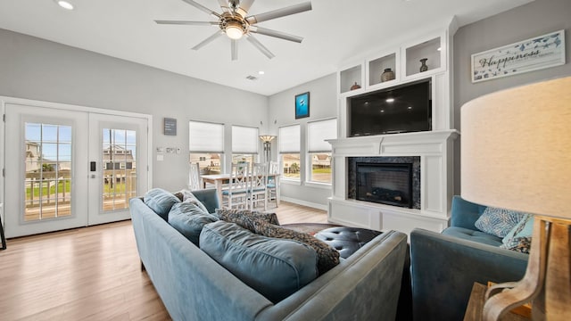 21530 San Luis Pass Rd, Galveston, TX 77554 - living area featuring wood finished floors, ceiling fan, healthy amount of natural light, a high end fireplace, and recessed lighting