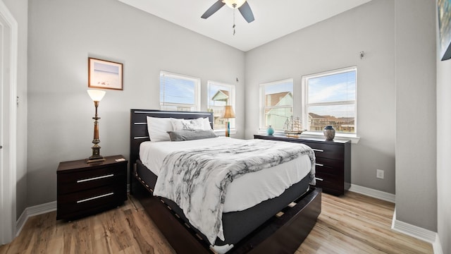 21530 San Luis Pass Rd, Galveston, TX 77554 - bedroom with baseboards, light wood-type flooring, and ceiling fan