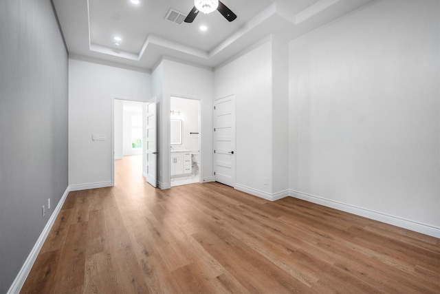 243 Teewood Ct, Montgomery, TX 77356 - unfurnished room featuring a tray ceiling, light wood-type flooring, ceiling fan, recessed lighting, and baseboards