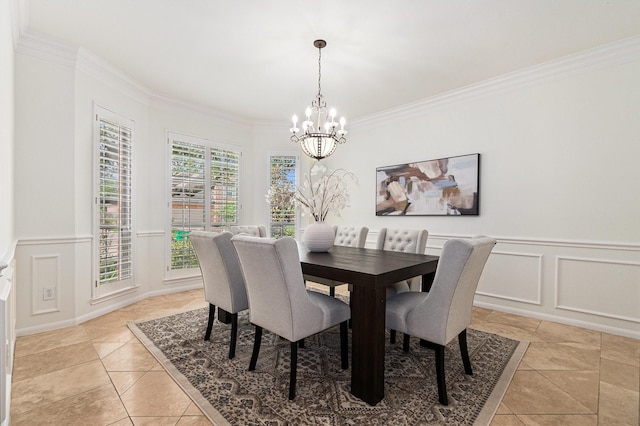 15814 Lake Loop Dr, Cypress, TX 77433 - dining area with a chandelier, crown molding, a decorative wall, wainscoting, and light tile patterned flooring