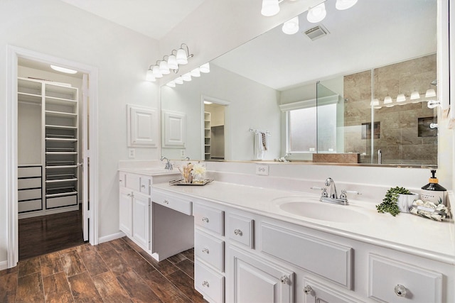 15814 Lake Loop Dr, Cypress, TX 77433 - full bath featuring double vanity, a walk in closet, a shower stall, and wood finished floors