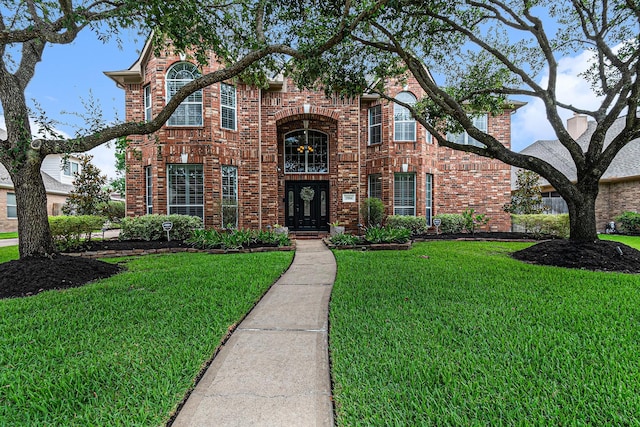 15814 Lake Loop Dr, Cypress, TX 77433 - traditional home featuring a front yard and brick siding