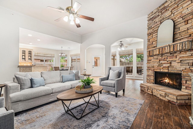 15814 Lake Loop Dr, Cypress, TX 77433 - living room featuring a ceiling fan, a fireplace, arched walkways, hardwood / wood-style floors, and plenty of natural light