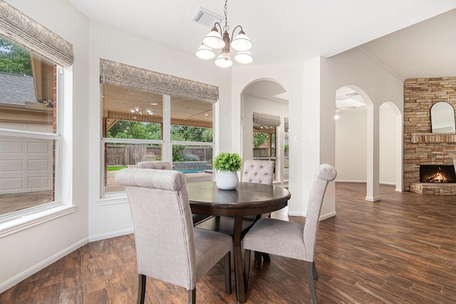 15814 Lake Loop Dr, Cypress, TX 77433 - dining space with plenty of natural light, wood finished floors, arched walkways, and a fireplace