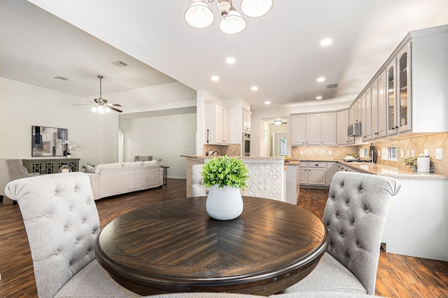 15814 Lake Loop Dr, Cypress, TX 77433 - dining room featuring a chandelier, recessed lighting, a ceiling fan, dark wood-style floors, and ornamental molding