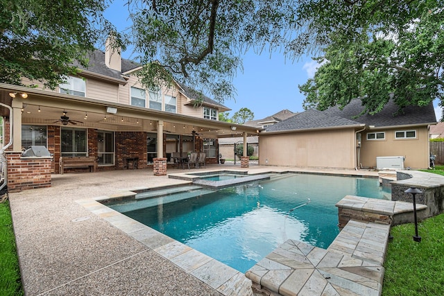 15814 Lake Loop Dr, Cypress, TX 77433 - view of swimming pool with an outdoor kitchen, a ceiling fan, a patio area, and a pool with connected hot tub