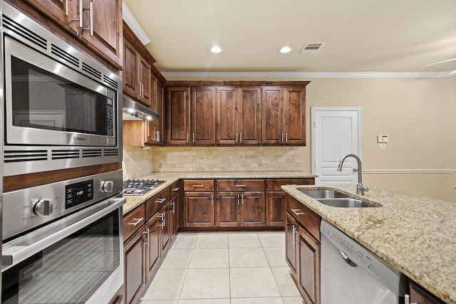 1121 Beall Landing Ct, Houston, TX 77008 - kitchen with appliances with stainless steel finishes, a sink, crown molding, light stone countertops, and decorative backsplash