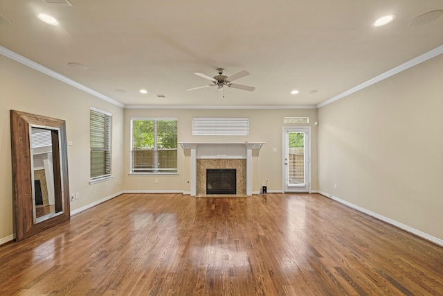 1121 Beall Landing Ct, Houston, TX 77008 - unfurnished living room featuring a premium fireplace, plenty of natural light, wood finished floors, baseboards, and crown molding