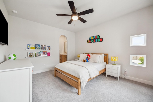 11011 Heartleaf Aster Way, Cypress, TX 77433 - bedroom with arched walkways, light carpet, baseboards, and a ceiling fan